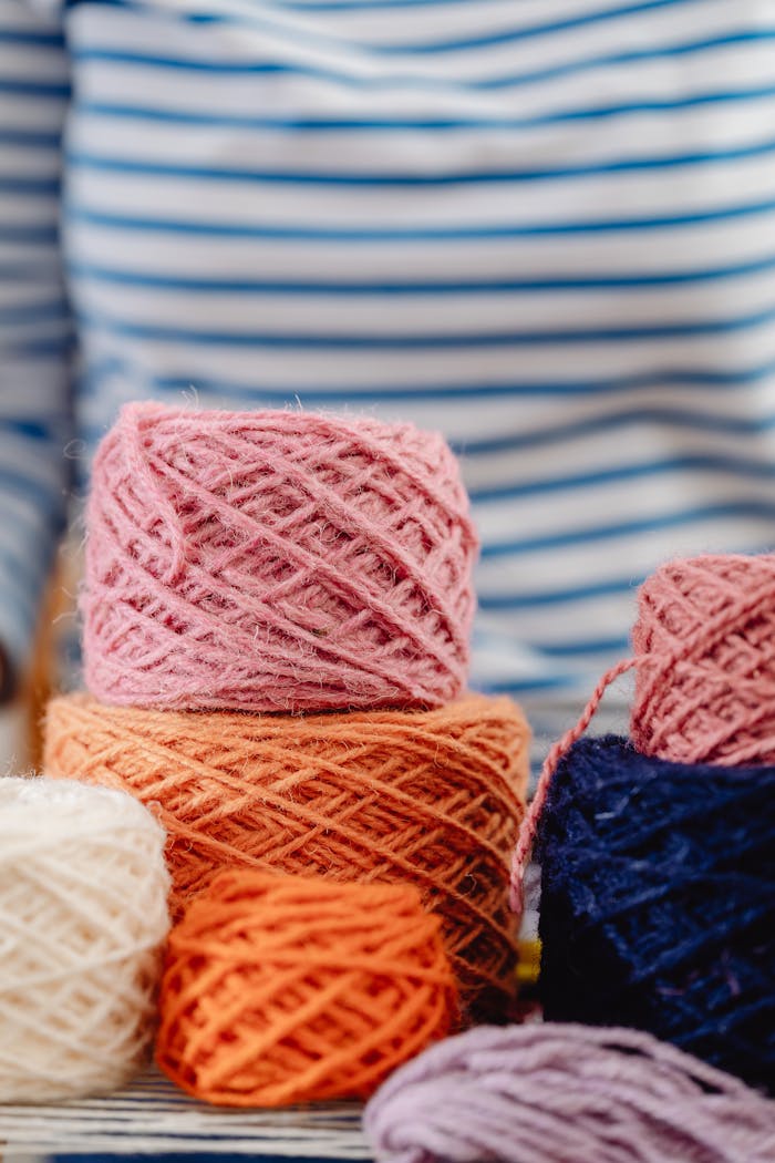 Piles of colorful yarn balls perfect for knitting, crochet, and crafting projects.